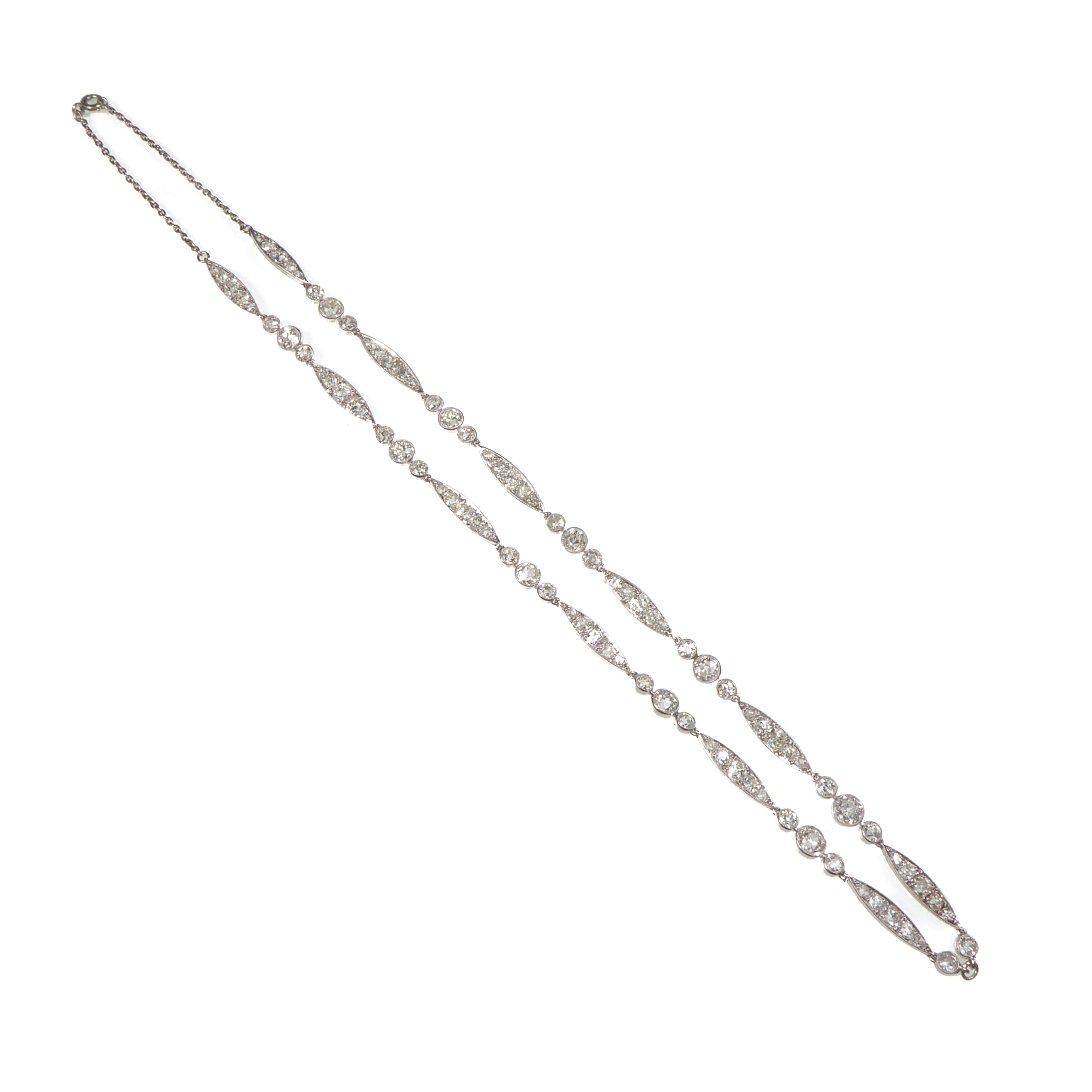 Early 20th century diamond and platinum chain necklace, probably French c.1910, alternating navette shaped clusters with graduated collet trios,